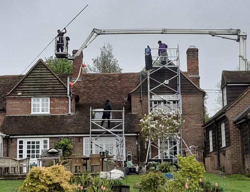 The Roof Moss Cleaners using cherry picker and scaffolding to clean roof safely and professionally in Burwell, Cambridgeshire