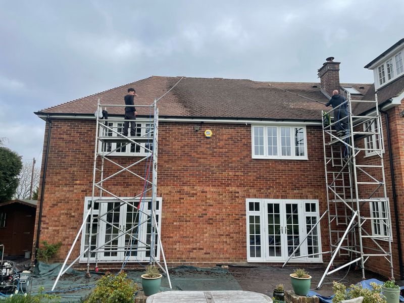 Roof cleaning carried out safely from scaffold towers by The Roof Moss Cleaners in Burwell
